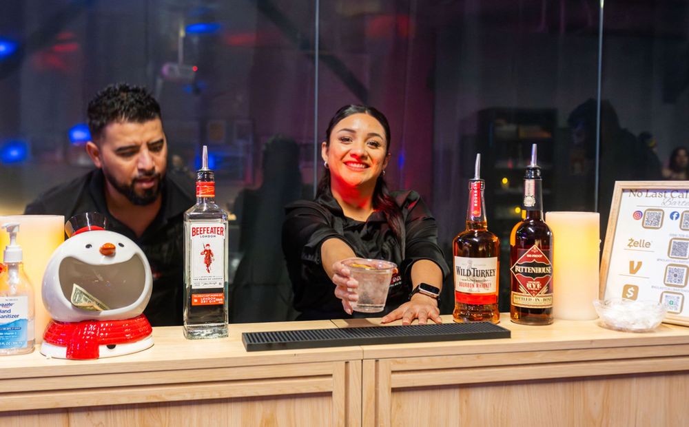 Adina preparing cocktails for guests at a private event